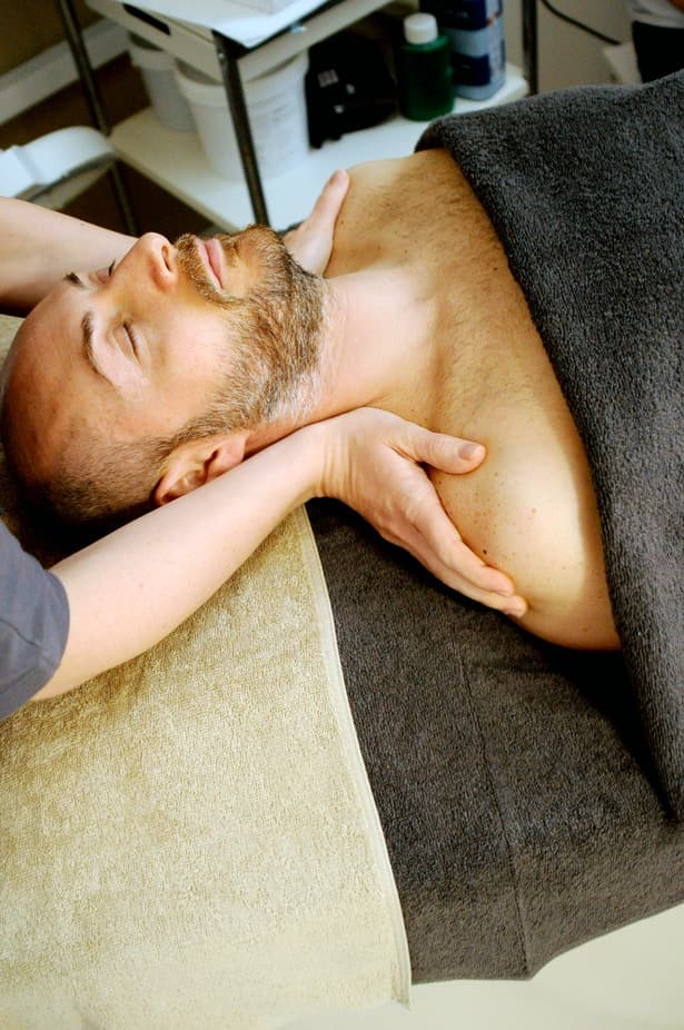 Therapist performing a soothing massage on a client at Heaven Spa in Iowa